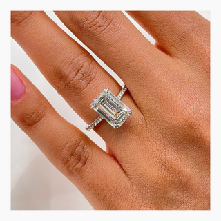 Emerald cut lab grown diamond engagement ring with wide pave band in 14K gold, showcasing clean lines and radiant sparkle.