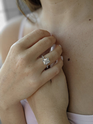 Emerald cut lab grown diamond dainty engagement ring in 14K gold with delicate setting, designed for subtle sparkle and elegance.