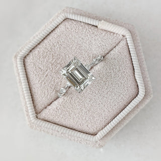 Emerald cut lab grown diamond dainty engagement ring in 14K gold with delicate setting, designed for subtle sparkle and elegance.