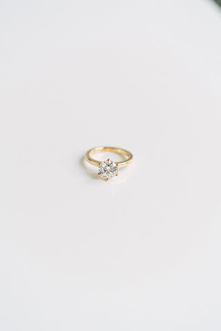Round lab grown diamond solitaire engagement ring in prong setting, crafted in 14K gold for timeless and ethical elegance.