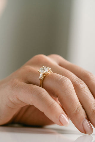 Round lab grown diamond engagement ring with three stone setting in 14K gold, symbolizing love’s past, present, and future.