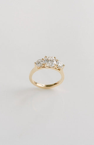 Three stone engagement ring with round lab grown diamonds set in 14K gold, ethically crafted for classic brilliance and balance.