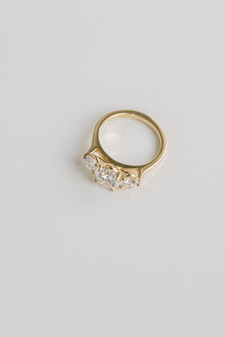 Three stone engagement ring with round lab grown diamonds set in 14K gold, ethically crafted for classic brilliance and balance.