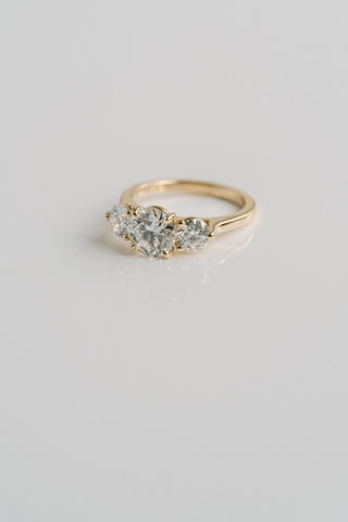 Three stone engagement ring with round lab grown diamonds set in 14K gold, ethically crafted for classic brilliance and balance.