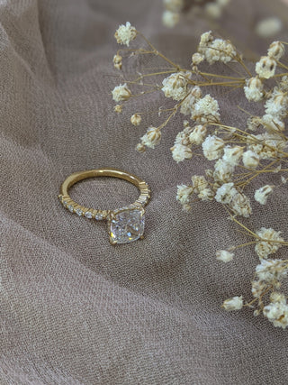Cushion cut lab grown diamond engagement ring with pave band in 14K gold, featuring soft corners and radiant sparkle.