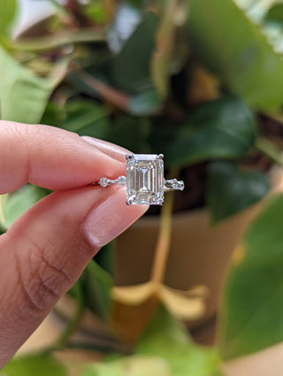 Emerald cut lab grown diamond dainty engagement ring in 14K gold with delicate setting, designed for subtle sparkle and elegance.