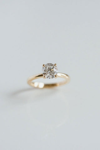 Round lab grown diamond solitaire engagement ring in 14K gold with sleek prong setting, handcrafted for timeless elegance.