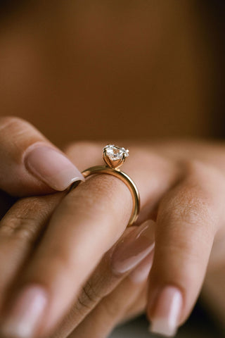 Round lab grown diamond solitaire engagement ring in 14K gold with sleek prong setting, handcrafted for timeless elegance.