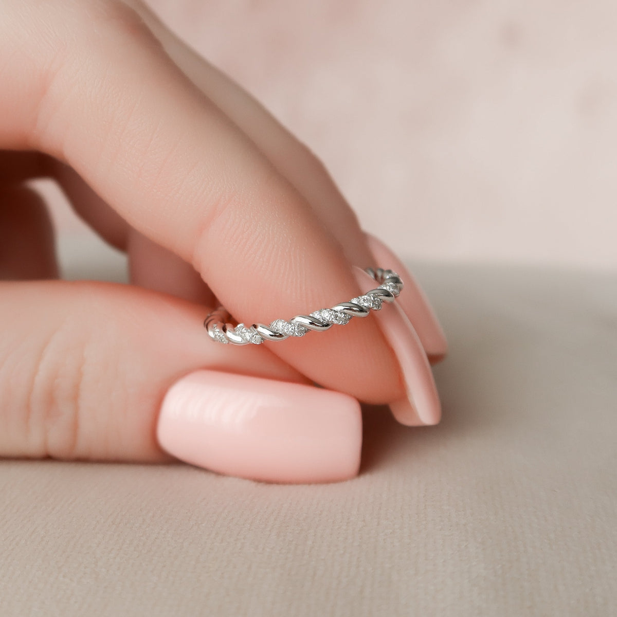 Twisted wedding band with round diamonds – elegant and unique braided design