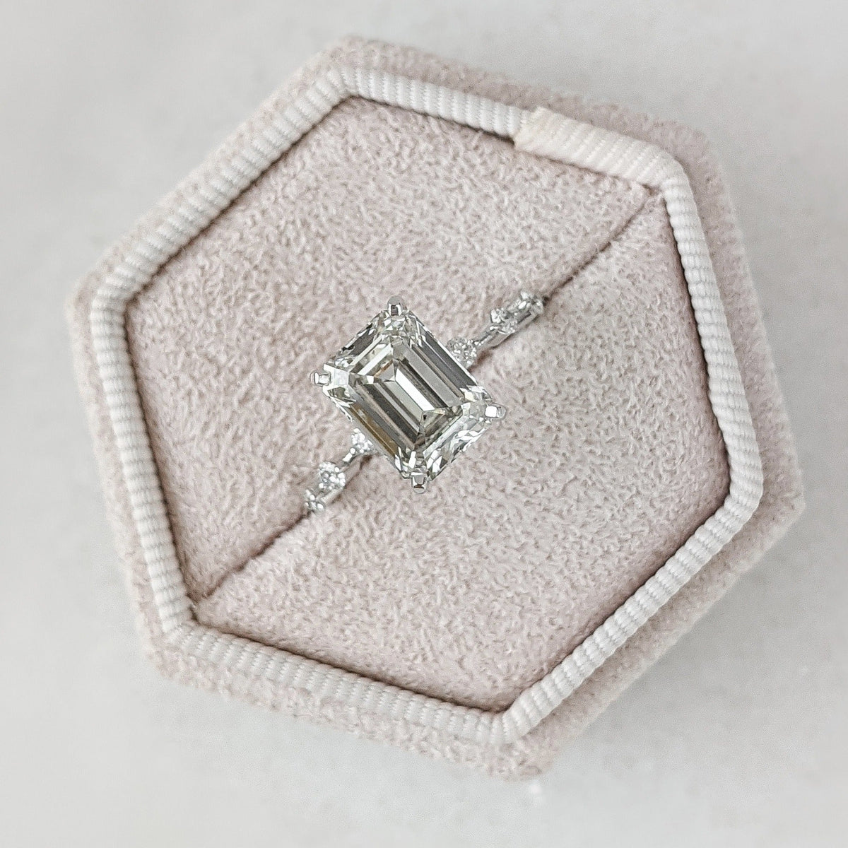 Emerald cut lab grown diamond dainty engagement ring in 14K gold with delicate setting, designed for subtle sparkle and elegance.