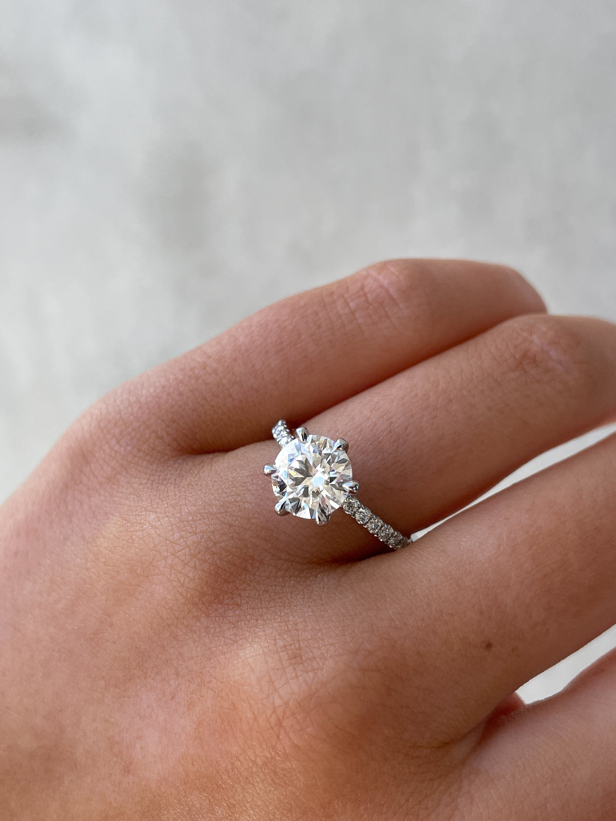 Round Cut Pave Lab Grown Diamond Engagement Ring with sparkling round center and pave band
