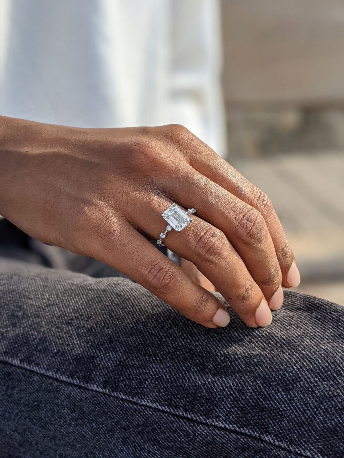 Emerald cut lab grown diamond dainty engagement ring in 14K gold with delicate setting, designed for subtle sparkle and elegance.