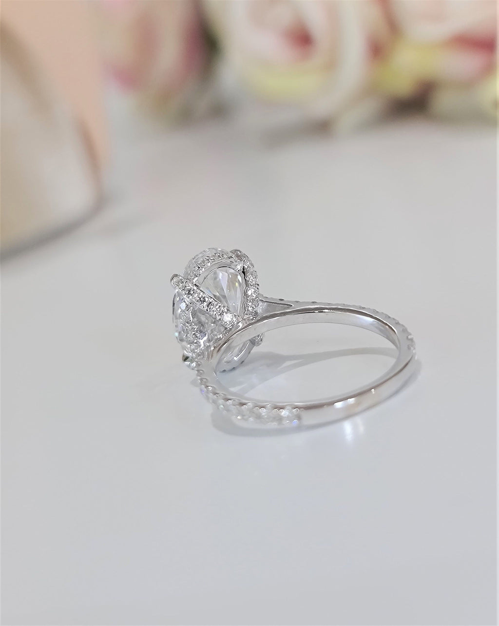Oval Hidden Halo Lab Grown Diamond Engagement Ring with oval cut center and pave band