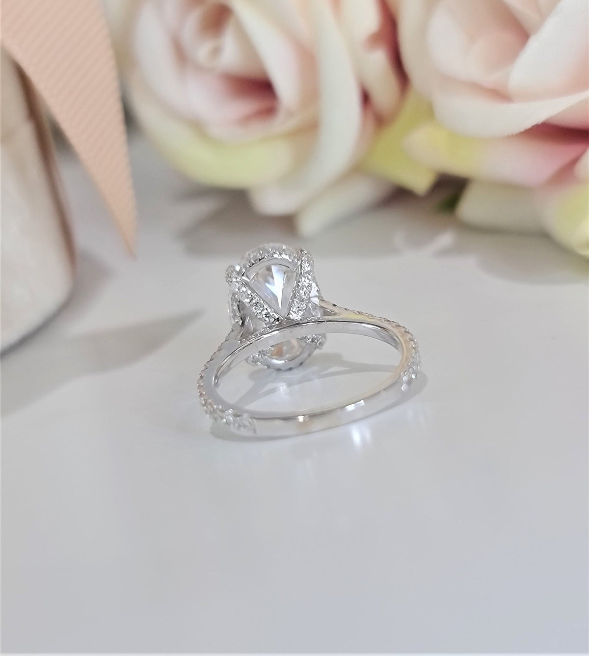 Oval Hidden Halo Lab Grown Diamond Engagement Ring with oval cut center and pave band