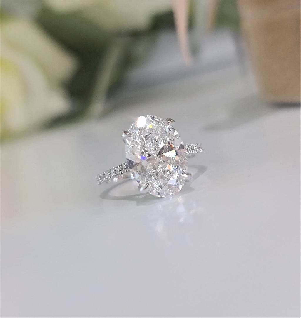 Oval Hidden Halo Lab Grown Diamond Engagement Ring with oval cut center and pave band