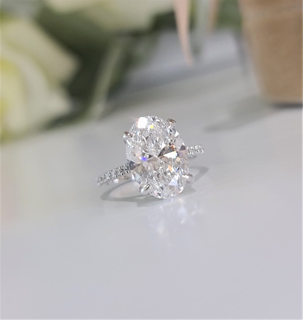 Oval Hidden Halo Lab Grown Diamond Engagement Ring with oval cut center and pave band