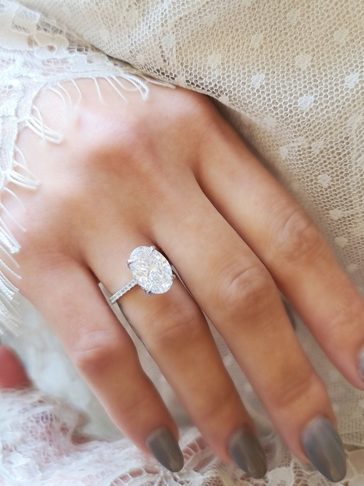 Oval Hidden Halo Lab Grown Diamond Engagement Ring with oval cut center and pave band