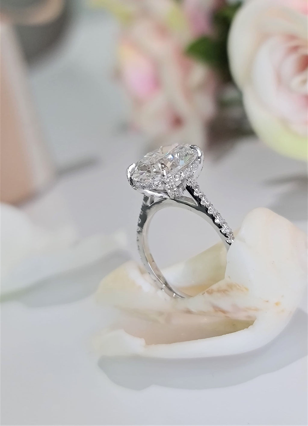 Oval Hidden Halo Lab Grown Diamond Engagement Ring with oval cut center and pave band