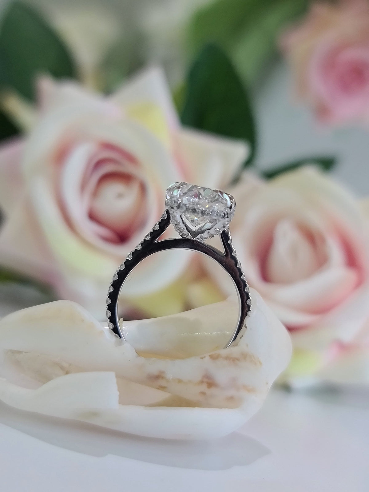 Oval Hidden Halo Lab Grown Diamond Engagement Ring with oval cut center and pave band