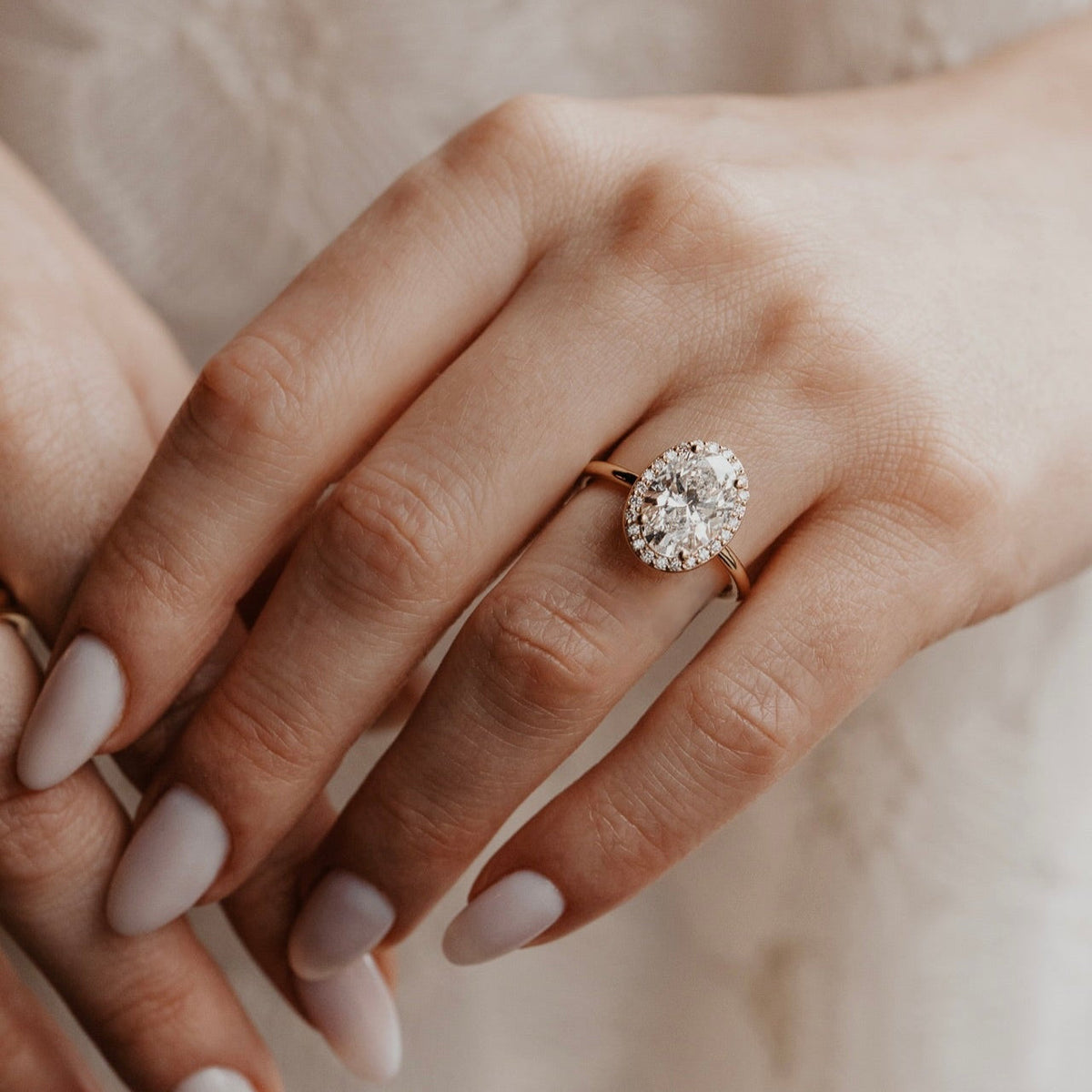 Oval Diamond Encircled Halo Engagement Ring
