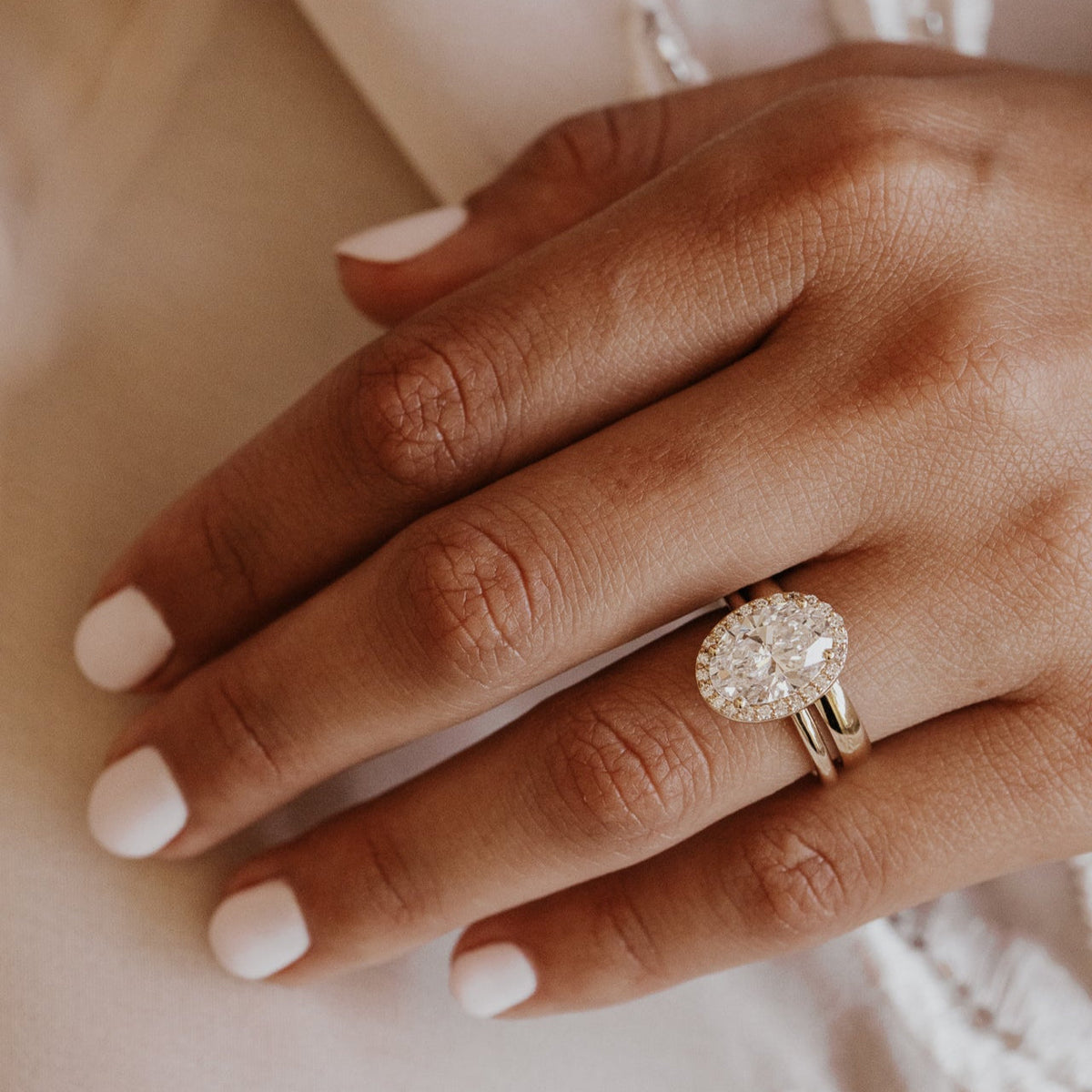 Oval Diamond Encircled Halo Engagement Ring